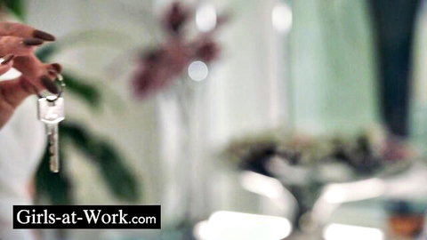 Manicured hand with long nails holding keys, teasing office vibe