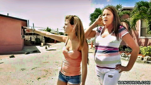 Two trailer park girls in casual outfits posing outdoors, one pointing excitedly
