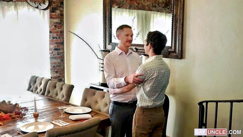 Gay DILF uncle intimately embraces young curly-haired nephew in cozy dining room foreplay