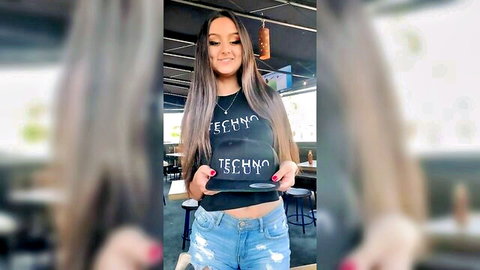 Eliza Ibarra smiling in black techno crop top and ripped jeans