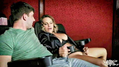 Blonde shemale in black lingerie and jacket teased by man in cinema