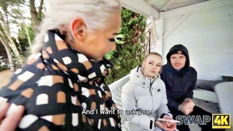Two blondes and a guy in jackets outdoors before hot threesome