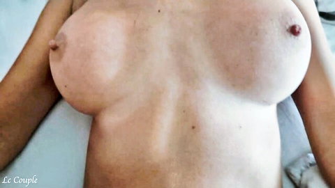 Busty woman squeezes her massive fake tits and hard pink nipples closeup