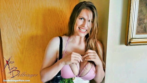 Xev Bellringer smiling in pink lace lingerie, teasing cleavage with big breasts