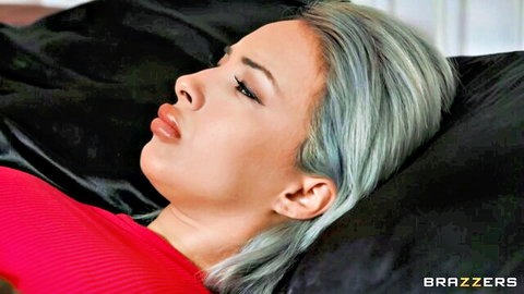 Lauren Pixie seductive side profile on bed, blue hair, red top allure
