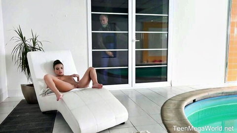 Petite brunette teen babe spreads shaved pussy and small tits on poolside chaise lounge with old man watching