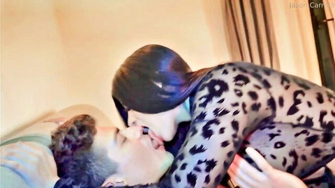 Brunette in sheer leopard bodysuit passionately french kissing man on bed