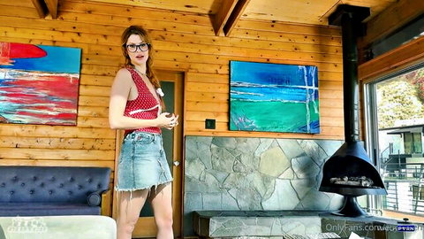 Elly Clutch in red tank top and denim shorts, sexy OnlyFans pose