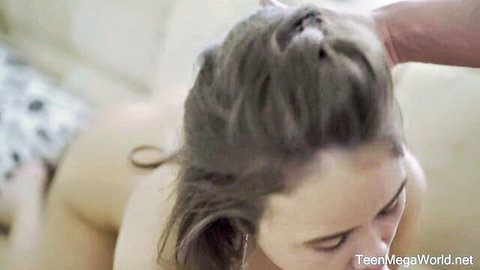 Brunette woman nude with hair pulled back in intense bedroom encounter