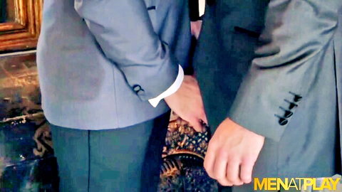 Suited man gropes coworker's crotch from behind in gay office foreplay