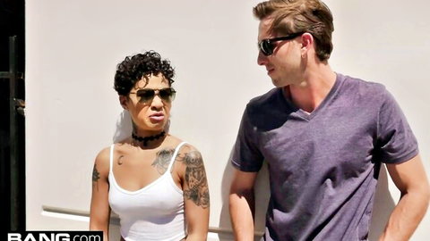Honey Gold in sunglasses and tank top posing with male partner outdoors