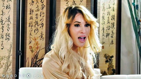 Blonde babe with long hair and wide open mouth sitting clothed in oriental room