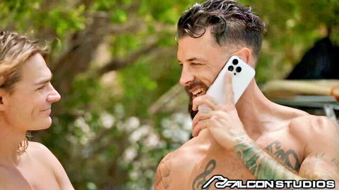 Muscular bearded hunk chats shirtless with long-haired jock after surfing