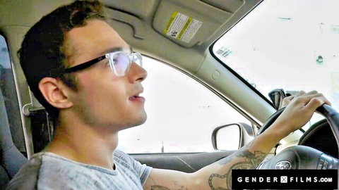 Tattooed guy with glasses driving car in pickup scene