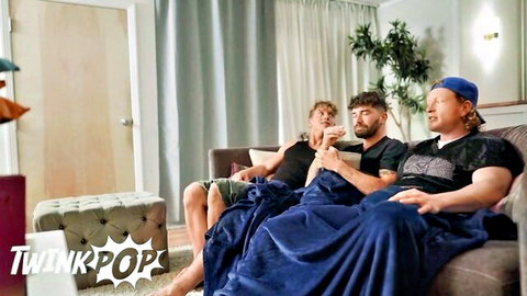 Three fit guys on couch under blanket, interrupted game leads to trans sex