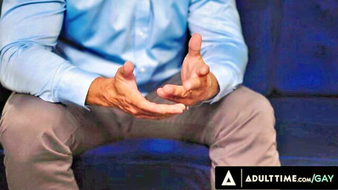 Mature DILF in blue shirt spreads hands teasing big cock bulge on couch gay porn