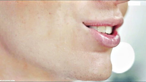 Close-up of glossy parted lips and teeth smiling seductively for blowjob tease