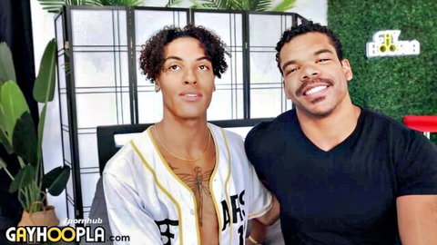 Two muscular ebony hunks smiling and posing together, one in open Lakers jersey showing chest