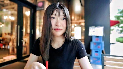 Fascinating Asian F-cup beauty in black t-shirt, smiling casually