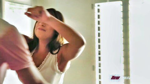 Ella Knox in passionate embrace, white lace top, intense adult scene