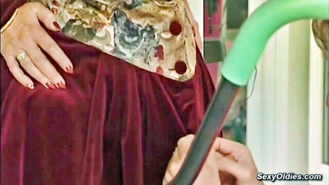 Mature German redhead Marta M in red velvet dress teasing with green toy