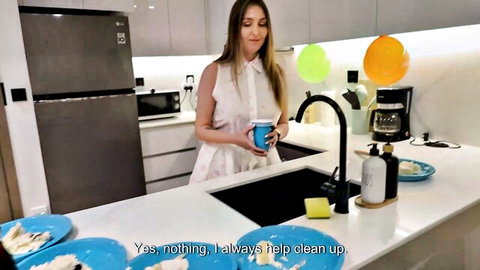 Blonde MILF in white blouse cleaning up in kitchen after party