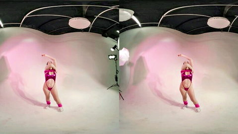 Skinny fair teen in revealing pink strappy lingerie poses seductively with arms up and legs spread in VR studio