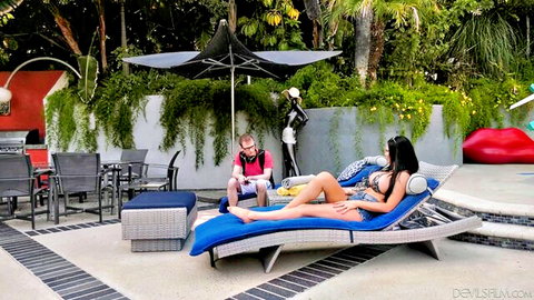 Curvy brunette MILF in skimpy bikini lounges seductively by pool as guy watches