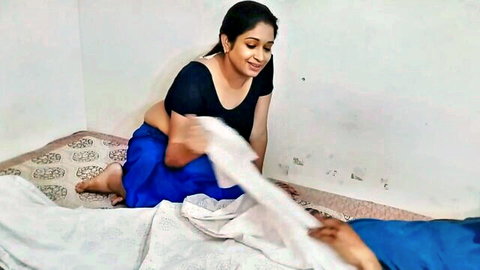 Curvy Indian wife in black blouse and blue saree teases smiling with big tits cleavage on bed
