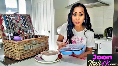Cute Asian Thai amateur babe in tight white shirt holding food container with picnic basket in kitchen
