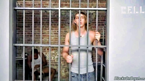Twink Ares grips prison bars as black cellmate watches hungrily