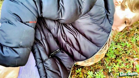 Lisa-Sophie in outdoor adventure gone wild, blonde on forest floor in puffy jacket