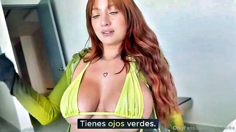 Redhead with green eyes teasing in revealing green top, big cleavage OnlyFans style