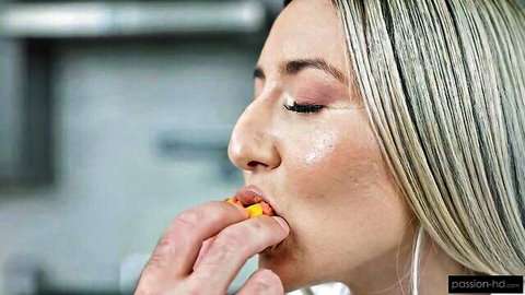 Sweet Sophia seductively eats orange snack fed by hand in close-up tease