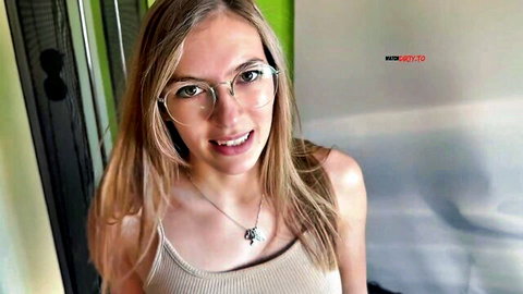Blonde babe with glasses smiling in tight tank top showing big tits POV