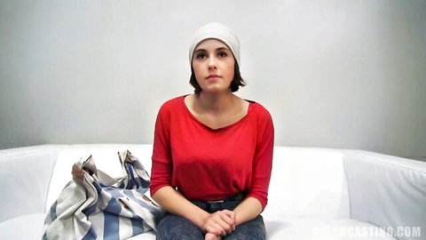 Freckled Czech amateur sits nervously on casting couch in red sweater and beanie
