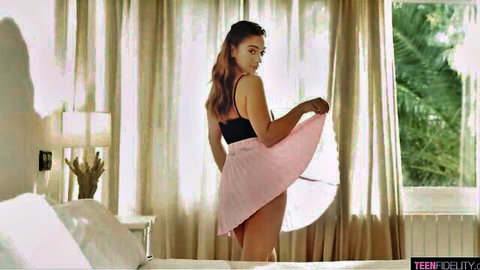 Skinny brunette teen lifts pink mini skirt teasing her tight ass in sunlit bedroom