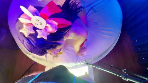 Ko Ko as Ai Hoshino in pink bunny ears cosplay, seductive pose