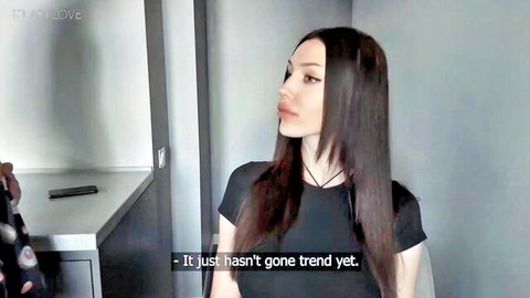 Aliz in black top and choker, long dark hair side profile