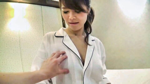 Izumi in white pajama top, hand on big tits cleavage