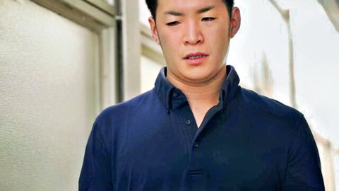 Handsome Asian brother-in-law in fitted blue polo, intense gaze