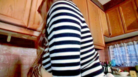 Busty MILF in striped sweater bending over in kitchen