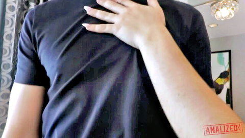 Pale hand with pink nails groping man's navy shirt over toned chest