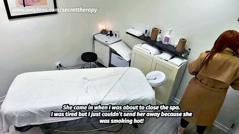 Sexy redhead babe in trenchcoat bending over massage table in spa showing big ass