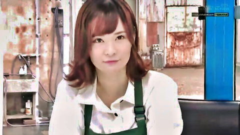 Cute Asian woman with red hair in white shirt and green apron, smiling in cafe setting