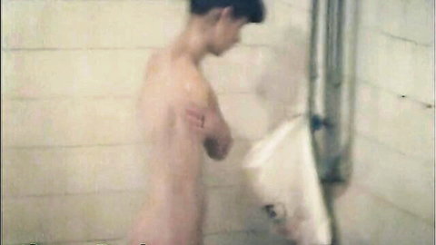 Slim white teen boy nude in shower room at urinal, voyeur cam