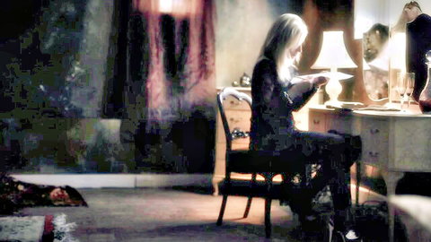 Blonde MILF at vanity mirror in black dress, soft teasing scene