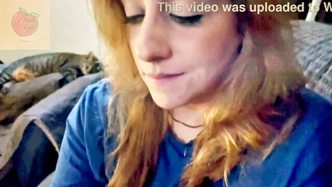 Redhead stepmom in blue shirt during cozy movie night