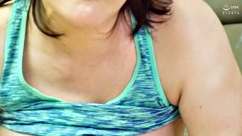 Chubby Japanese MILF in tight teal sports bra showing deep cleavage and medium tits