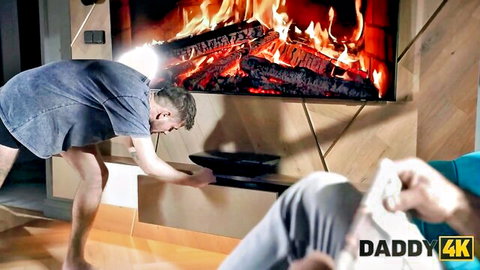 DILF bends over pulling down shorts exposing bare muscular ass near fireplace TV